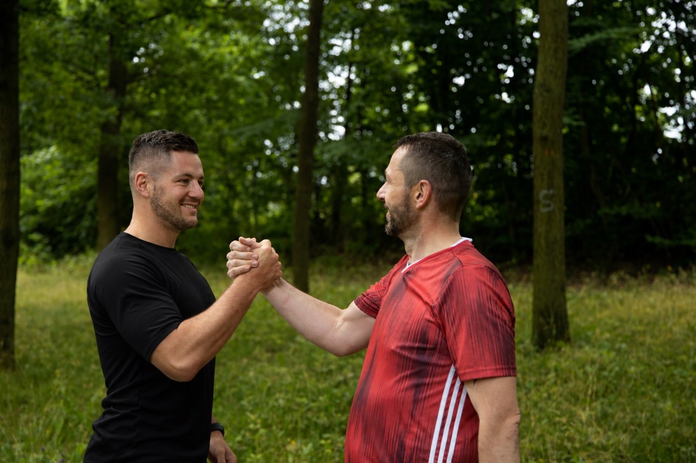 Wolf Hagen mit Kunde nach dem Training – Handshake im Wald